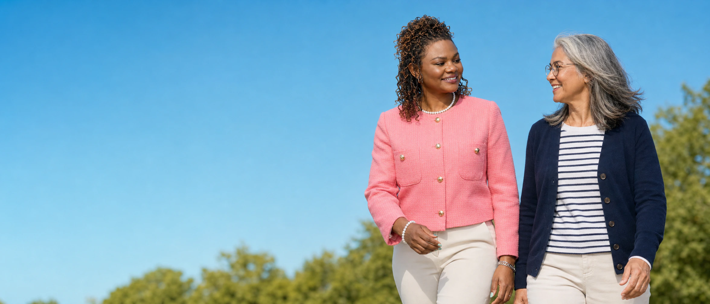 Dr. Ezeh-Aideyan walking and speaking with an older adult