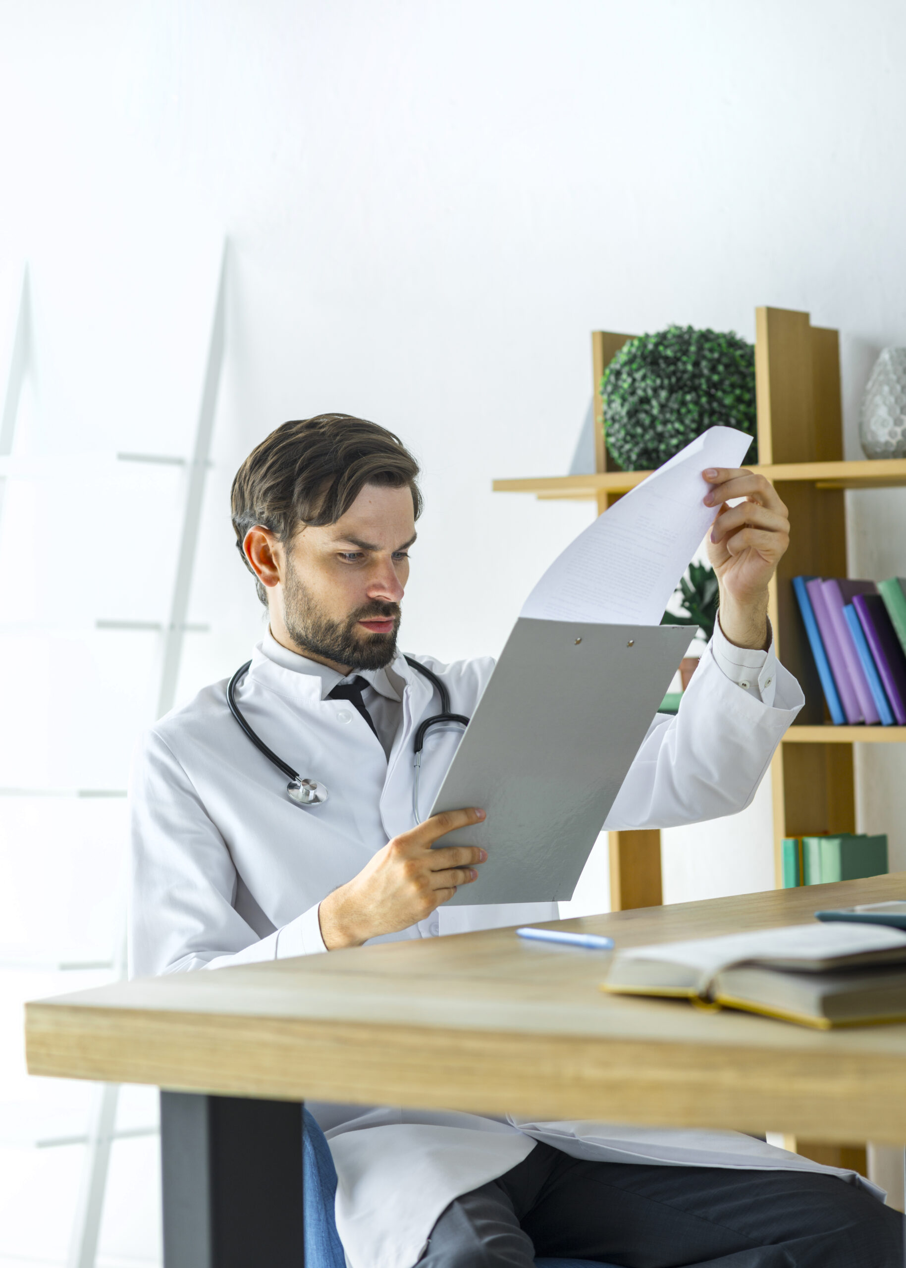 young-doctor-reading-notes-clipboard